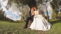 Bride and Groom in the Park with Candies in Hands