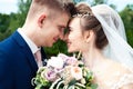 Bride and groom in a park. Kissing couple newlyweds bride and groom at wedding in nature green forest are kissing photo portrait.W Royalty Free Stock Photo