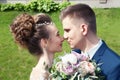 Bride and groom in a park. Kissing couple newlyweds bride and groom at wedding in nature green forest are kissing photo Royalty Free Stock Photo