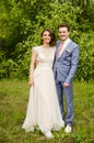 Bride and groom in a park kissing.couple newlyweds bride and groom at a wedding in nature green forest are kissing photo portrait. Royalty Free Stock Photo