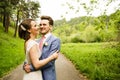 Bride and groom in a park kissing.couple newlyweds bride and groom at a wedding in nature green forest are kissing photo portrait. Royalty Free Stock Photo