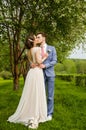 Bride and groom in a park kissing.couple newlyweds bride and groom at a wedding in nature green forest are kissing photo portrait. Royalty Free Stock Photo