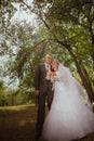 Bride and groom in a park kissing.couple newlyweds bride and groom at a wedding in nature green forest are kissing photo Royalty Free Stock Photo