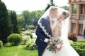 Bride and groom in a park. Kissing couple newlyweds bride and groom at wedding in nature green forest are kissing photo portrait.W Royalty Free Stock Photo