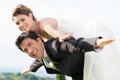 Bride and groom piggyback Royalty Free Stock Photo