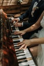 The bride and groom play the piano in two hands Royalty Free Stock Photo
