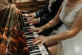 The bride and groom play the piano in two hands Royalty Free Stock Photo