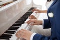 The bride and groom play the piano in two hands
