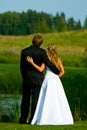 Bride and groom at pond Royalty Free Stock Photo