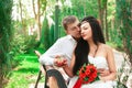 Bride and groom posing in amusement park Royalty Free Stock Photo