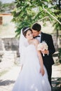 Bride and groom posing on the background of ancient ruins