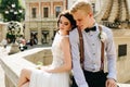 Bride and groom posing at the fountain