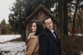 Bride and groom posing at old well with moss in autumn garden. happy newlywed couple embracing at wooden house in woods. gorgeous Royalty Free Stock Photo