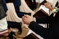 Bride and groom preparing for communion on knees at wedding ceremony in church