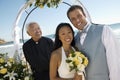 Bride and Groom with priest under archway Royalty Free Stock Photo