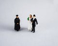 Bride, groom and priest on white