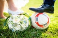 Bride and groom put their feet on the football Royalty Free Stock Photo