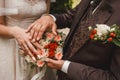 The bride and groom put their hands on the wedding decorative bouquet of flowers of roses close-up Royalty Free Stock Photo