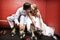 Bride and Groom putting on ice skates