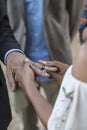 Bride and groom putting rings on each other`s fingers during outdoor wedding Royalty Free Stock Photo