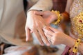 Bride and Groom putting wedding ring on finger, Thai wedding engagement ceremony Royalty Free Stock Photo