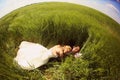 Bride and groom relaxing on the fields Royalty Free Stock Photo