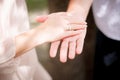 bride and groom with rings on their ring fingers hold their hands together. Summer wedding ceremony outdoors Royalty Free Stock Photo