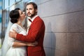 Bride and groom, romantic wedding couple in a passionate outburst, near walls of building. Royalty Free Stock Photo