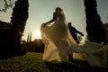 Bride and groom running away at sunset, garden wedding at sunset, hacienda wedding in Mexico Royalty Free Stock Photo