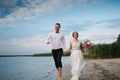 The bride and groom running on the beach, wedding accessories Royalty Free Stock Photo