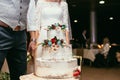 Bride and groom with rustic wedding cake on wedding banquet with Royalty Free Stock Photo