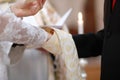 Bride and groom's hands and priest's cassock