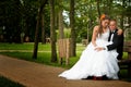 Bride and groom seated in park