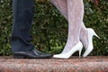 Bride and groom shoes closeup on marble on nature background.