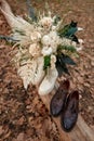 bride and groom shoes, wedding bouquet outdoor.