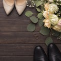 Bride groom shoes and wedding small bouquet of roses Royalty Free Stock Photo