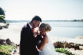 Bride and groom shooting and walking along the river Royalty Free Stock Photo