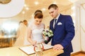 Bride and groom signing marriage license Royalty Free Stock Photo