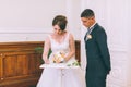 Bride and groom signing marriage license Royalty Free Stock Photo