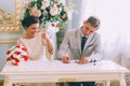 Bride and groom signing marriage license