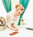 Bride and groom signing marriage license or wedding contract Royalty Free Stock Photo