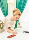 Bride and groom signing marriage license or wedding contract Royalty Free Stock Photo