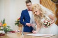 Bride and groom signing marriage wedding certificate Royalty Free Stock Photo