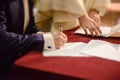 Bride and groom signing wedding contract proving their marriage Royalty Free Stock Photo