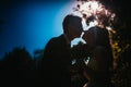 Bride and groom silhouettes on the background of the sky park