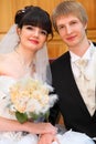 Bride and groom sit and hold each other by hand Royalty Free Stock Photo