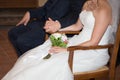 Bride and groom sitting at catholic wedding ceremony at church