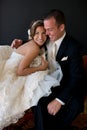 Bride and Groom sitting on couch Royalty Free Stock Photo