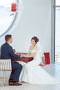 Bride and groom sitting in indoors cafe Royalty Free Stock Photo