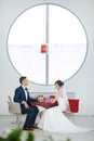 Bride and groom sitting in indoors cafe Royalty Free Stock Photo